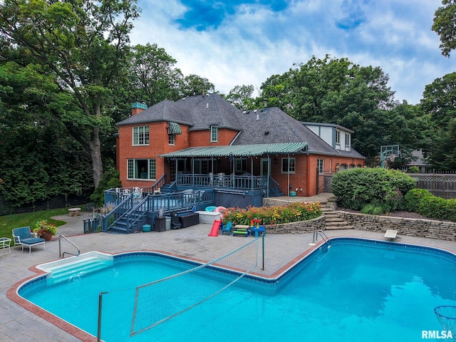512 Hidden Ln, Peoria, IL 61614 - outdoor pool featuring a patio, stairs, a wooden deck, and a diving board