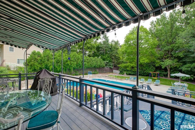 512 Hidden Ln, Peoria, IL 61614 - wooden terrace with view of scattered trees, outdoor dining space, and a patio area