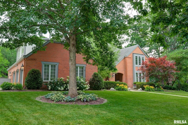 512 Hidden Ln, Peoria, IL 61614 - view of front of house featuring a front lawn, brick siding, and a garage