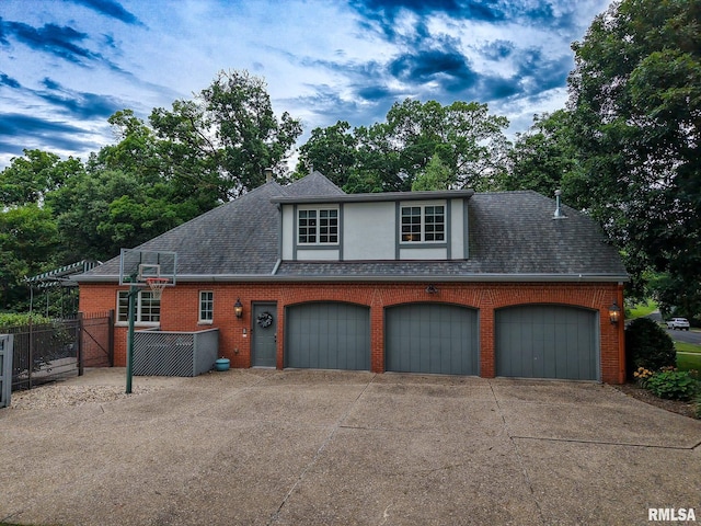 512 Hidden Ln, Peoria, IL 61614 - view of front of home with driveway, brick siding, a shingled roof, and stucco siding