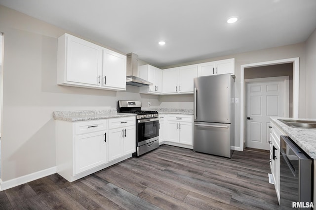 208 W Graze Ave, Dunlap, IL 61525 - kitchen featuring appliances with stainless steel finishes, wall chimney exhaust hood, dark wood-style flooring, white cabinets, and recessed lighting