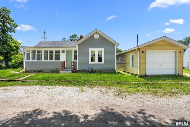 1013 N 2nd St, Pekin, IL 61554 - view of front of property featuring a garage, a sunroom, roof with shingles, driveway, and a front lawn