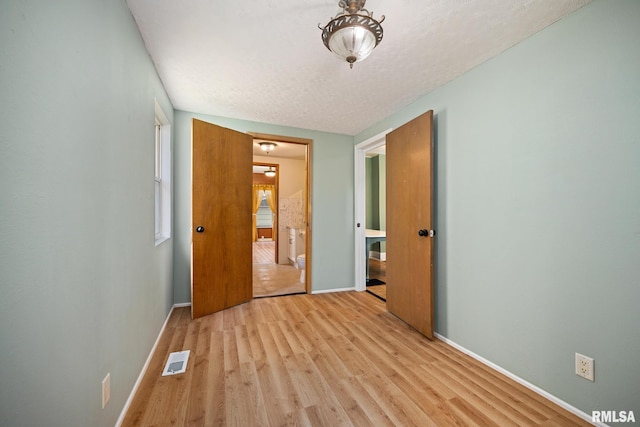 1013 N 2nd St, Pekin, IL 61554 - unfurnished bedroom featuring light wood finished floors and baseboards