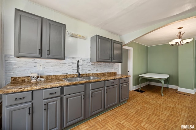 1013 N 2nd St, Pekin, IL 61554 - kitchen featuring arched walkways, gray cabinetry, and dark countertops