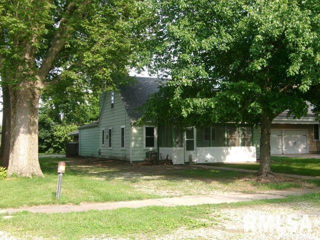 102 N Park Ave, Manito, IL 61546 - view of property hidden behind natural elements featuring a front yard and a shingled roof