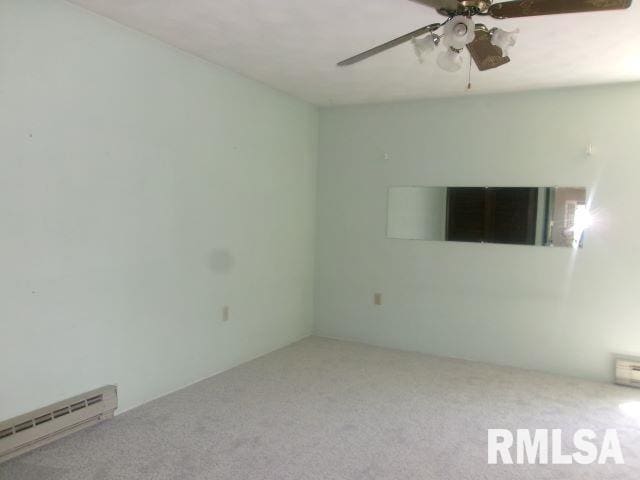 102 N Park Ave, Manito, IL 61546 - carpeted spare room with a baseboard heating unit and a ceiling fan