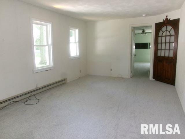 102 N Park Ave, Manito, IL 61546 - empty room featuring a baseboard radiator and carpet floors