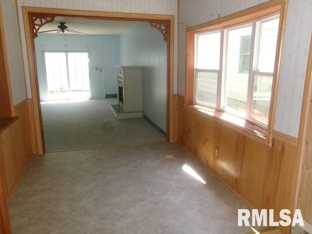102 N Park Ave, Manito, IL 61546 - hallway featuring carpet flooring, a wainscoted wall, wooden walls, and wallpapered walls
