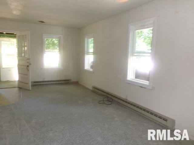102 N Park Ave, Manito, IL 61546 - carpeted spare room featuring a baseboard radiator
