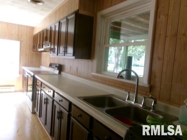 102 N Park Ave, Manito, IL 61546 - kitchen with range, wooden walls, light countertops, and range hood
