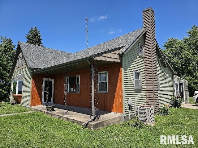 19635 E 800th St, Sciota, IL 61475 - rear view of house with a lawn, a chimney, and a shingled roof