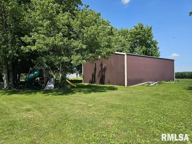 19635 E 800th St, Sciota, IL 61475 - view of grassy yard with a pole building, a playground, and an outdoor structure