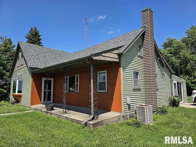 19635 E 800th St, Sciota, IL 61475 - rear view of house with a shingled roof, a yard, and a chimney