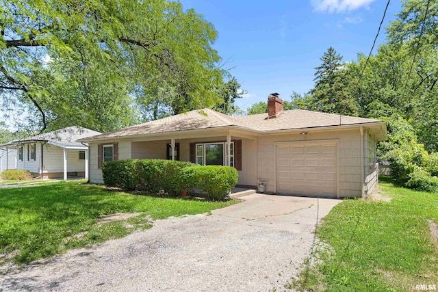 1726 N Pierson Dr, West Peoria, IL 61604 - single story home with an attached garage, a chimney, a front yard, and driveway