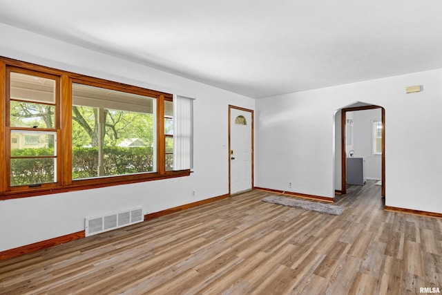 1726 N Pierson Dr, West Peoria, IL 61604 - empty room with arched walkways and light wood finished floors
