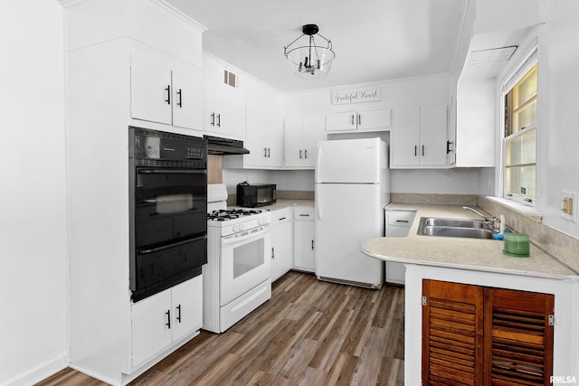 1726 N Pierson Dr, West Peoria, IL 61604 - kitchen with white appliances, under cabinet range hood, wood finished floors, light countertops, and ornamental molding