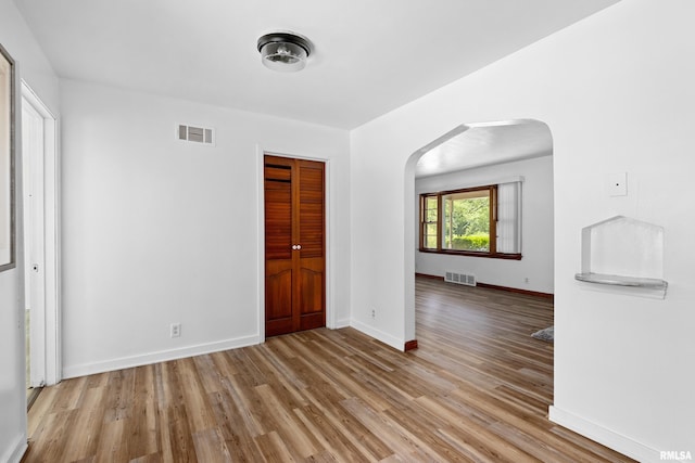 1726 N Pierson Dr, West Peoria, IL 61604 - unfurnished room with arched walkways and wood finished floors