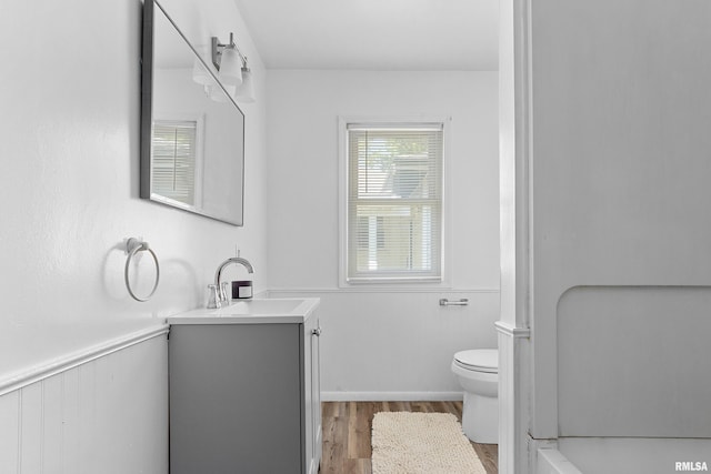 1726 N Pierson Dr, West Peoria, IL 61604 - full bath featuring vanity, wood finished floors, a bathtub, and wainscoting