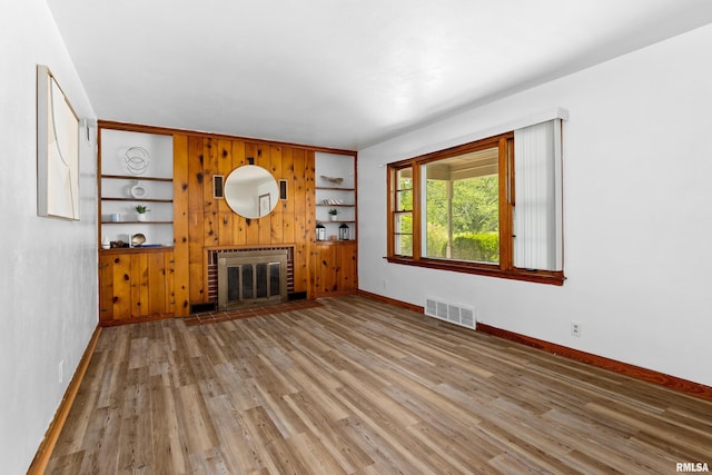 1726 N Pierson Dr, West Peoria, IL 61604 - unfurnished living room featuring wood finished floors and a brick fireplace