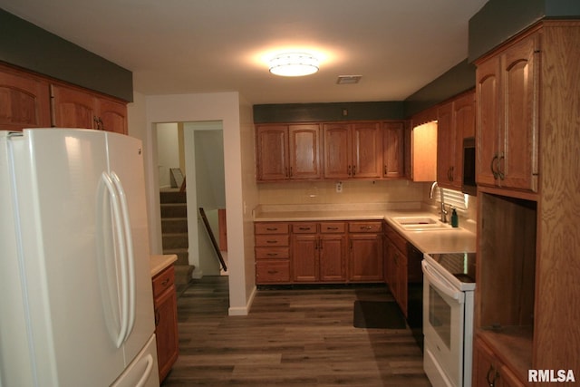 29724 Allentown Rd, Mackinaw, IL 61755 - kitchen featuring white appliances, brown cabinets, dark wood-type flooring, and light countertops