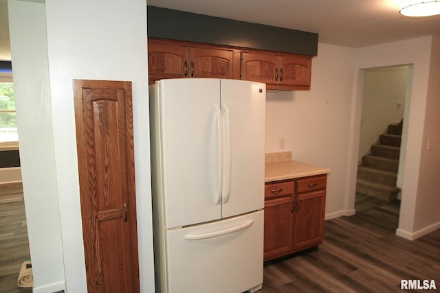 29724 Allentown Rd, Mackinaw, IL 61755 - kitchen with freestanding refrigerator, dark wood-style floors, brown cabinets, and light countertops