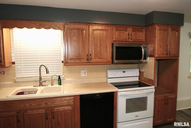 29724 Allentown Rd, Mackinaw, IL 61755 - kitchen with stainless steel microwave, white range with electric cooktop, black dishwasher, tasteful backsplash, and light countertops