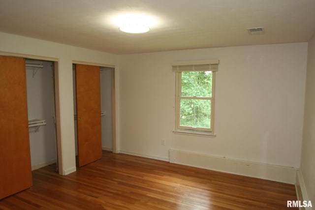 29724 Allentown Rd, Mackinaw, IL 61755 - unfurnished bedroom with wood finished floors and multiple closets