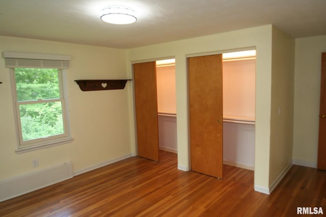 29724 Allentown Rd, Mackinaw, IL 61755 - unfurnished bedroom featuring wood finished floors and two closets