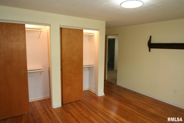 29724 Allentown Rd, Mackinaw, IL 61755 - unfurnished bedroom with wood finished floors and multiple closets