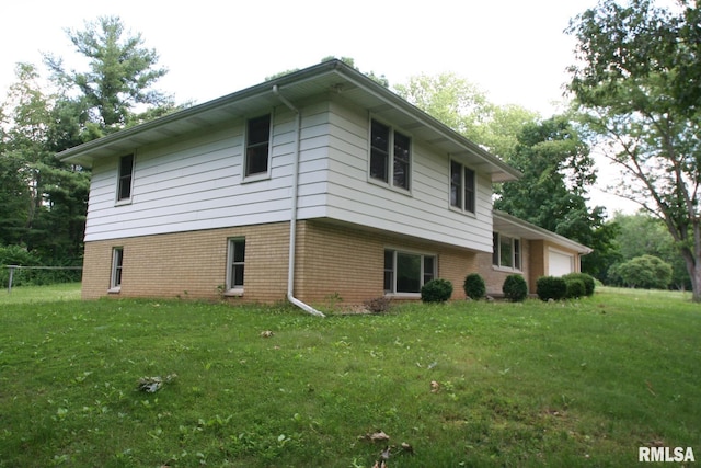 29724 Allentown Rd, Mackinaw, IL 61755 - view of home's exterior featuring an attached garage, a yard, and brick siding