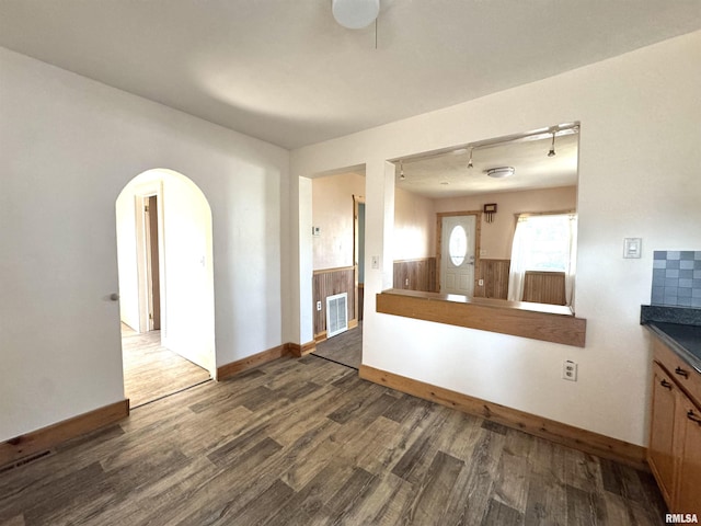 1406 6th St, Pekin, IL 61554 - unfurnished living room featuring dark wood-type flooring and arched walkways