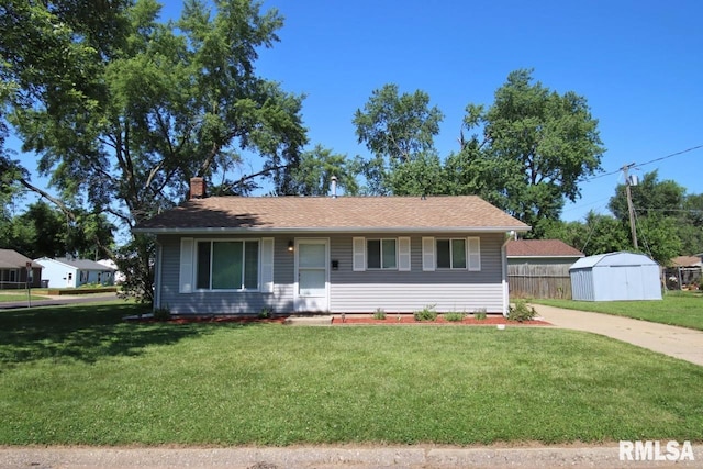 1409 Alton St, Pekin, IL 61554 - single story home featuring a chimney, a storage unit, and concrete driveway