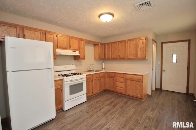 1409 Alton St, Pekin, IL 61554 - kitchen featuring white appliances, under cabinet range hood, light countertops, dark wood finished floors, and a textured ceiling