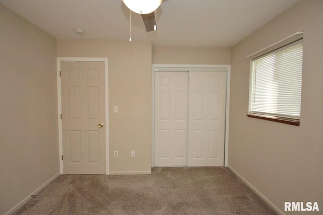 1409 Alton St, Pekin, IL 61554 - unfurnished bedroom with carpet, a closet, and a ceiling fan