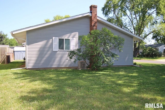 1409 Alton St, Pekin, IL 61554 - view of home's exterior featuring a yard and a chimney