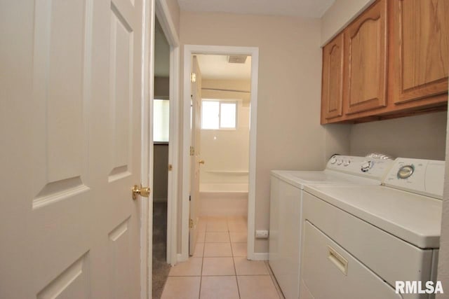 1409 Alton St, Pekin, IL 61554 - laundry area with cabinet space, washing machine and clothes dryer, and light tile patterned flooring