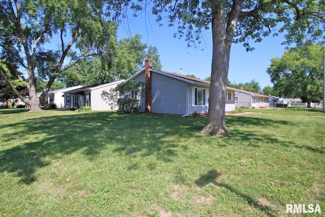1409 Alton St, Pekin, IL 61554 - view of side of home with a chimney and a lawn
