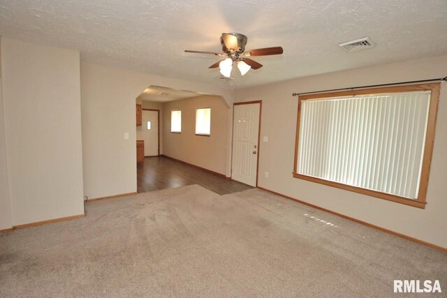 1409 Alton St, Pekin, IL 61554 - unfurnished room featuring carpet flooring, a ceiling fan, arched walkways, and a textured ceiling