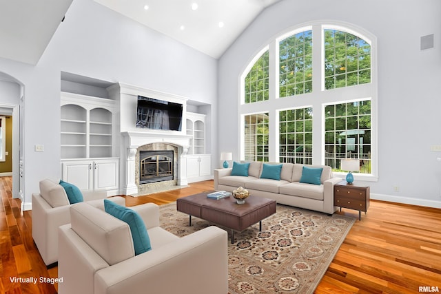 4851 Sheridan Rd, Groveland, IL 61535 - living room featuring high vaulted ceiling, wood finished floors, a premium fireplace, and recessed lighting
