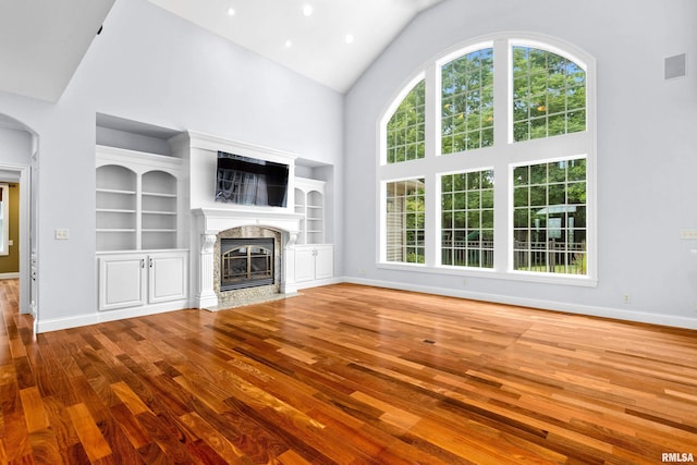4851 Sheridan Rd, Groveland, IL 61535 - unfurnished living room featuring wood finished floors, high vaulted ceiling, and a high end fireplace