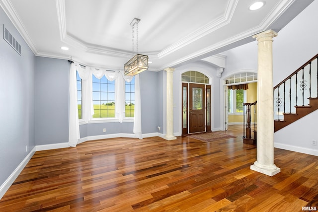 4851 Sheridan Rd, Groveland, IL 61535 - entryway featuring ornate columns, a tray ceiling, ornamental molding, wood finished floors, and stairway