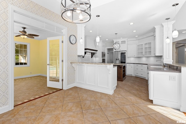 4851 Sheridan Rd, Groveland, IL 61535 - kitchen with a peninsula, stainless steel appliances, a ceiling fan, glass insert cabinets, and wallpapered walls