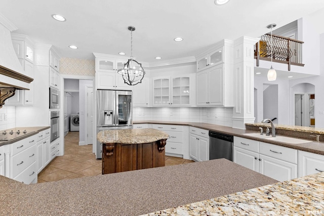 4851 Sheridan Rd, Groveland, IL 61535 - kitchen featuring appliances with stainless steel finishes, washer / clothes dryer, custom exhaust hood, white cabinets, and recessed lighting