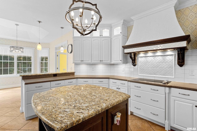 4851 Sheridan Rd, Groveland, IL 61535 - kitchen featuring custom range hood, black electric cooktop, a chandelier, light tile patterned flooring, and white cabinets