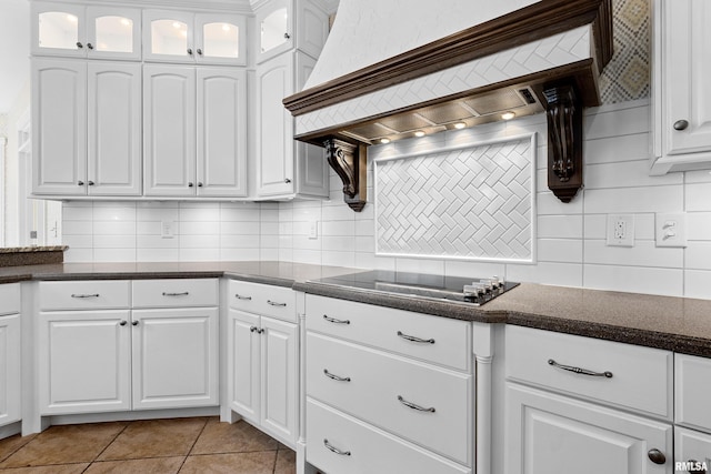 4851 Sheridan Rd, Groveland, IL 61535 - kitchen with black electric stovetop, decorative backsplash, premium range hood, and white cabinets