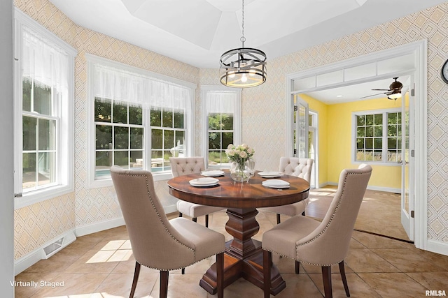 4851 Sheridan Rd, Groveland, IL 61535 - dining room with wallpapered walls, light tile patterned floors, a chandelier, plenty of natural light, and a ceiling fan