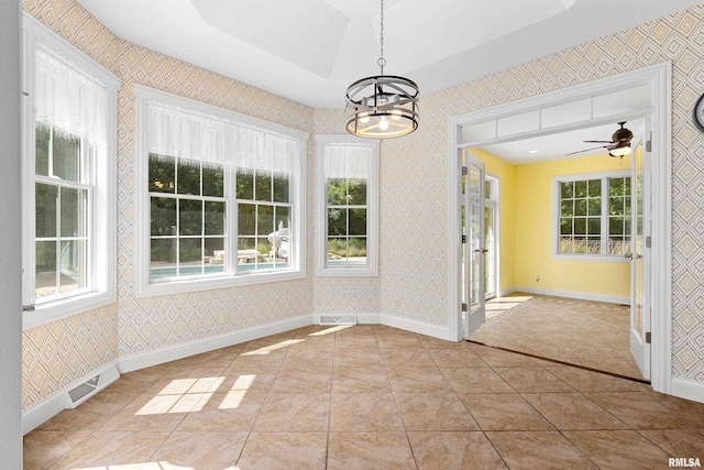 4851 Sheridan Rd, Groveland, IL 61535 - unfurnished dining area with wallpapered walls, a chandelier, ceiling fan, and tile patterned floors