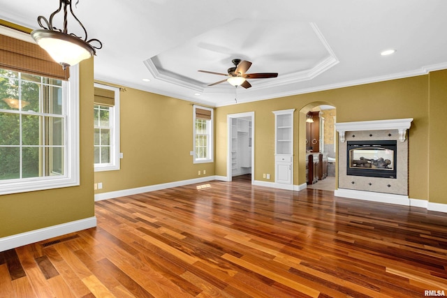 4851 Sheridan Rd, Groveland, IL 61535 - unfurnished living room with healthy amount of natural light, ornamental molding, wood finished floors, a ceiling fan, and arched walkways