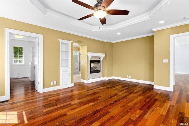 4851 Sheridan Rd, Groveland, IL 61535 - unfurnished living room featuring a raised ceiling, a ceiling fan, wood finished floors, arched walkways, and ornamental molding
