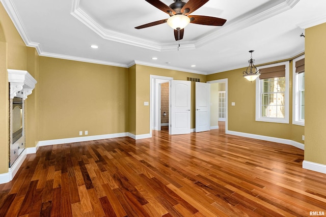 4851 Sheridan Rd, Groveland, IL 61535 - unfurnished living room with a raised ceiling, wood finished floors, ceiling fan, crown molding, and a fireplace
